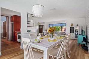 A modern kitchen with white cabinets, a stainless steel refrigerator, and a wooden countertop. - Heated Pool ,Mini Golf, Game Room, Near Beaches (Bradenton)