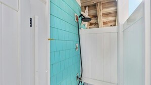 A bathroom with turquoise tiles, a showerhead, and a wooden ceiling. - A Little Piece Of Heaven-5BR-2nd Row-Pet Friendly (North Myrtle Beach)