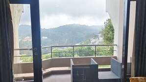 A balcony with a view of a mountainous landscape.
