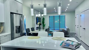 A modern kitchen with a large island, stainless steel appliances, and pendant lighting. - Spacious 3Story,3bedroom,Pets Park,Near UofA&more attractions.Luxury starts here (Edmonton)
