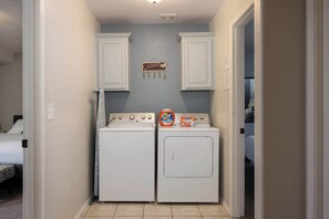 Convenient laundry facilities with two front-loading washing machines.
