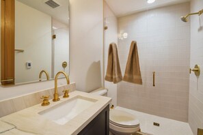 A bathroom with a sink, two gold faucets, a toilet, and a shower area with two towels hanging. - Old Town Alpine Vista: Near Park City Ski Resort (Park City)