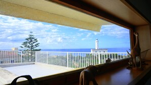 A balcony with a view of the sea, a white fence, and a tree. - Villa historic center sea view (Anzio)