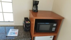 A kitchenette with a microwave, a coffee maker, and a refrigerator. - Affordable Getaway near Grand Canyon Sleeps 4 (Williams AZ 86046)