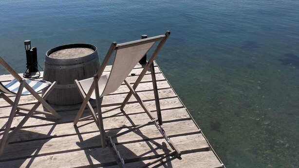 A wooden pier extending into calm water with clear skies. - T2 between sea and pond   (Sète)