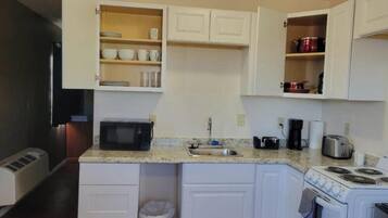 Microwave, stovetop, coffee/tea maker, dining tables
