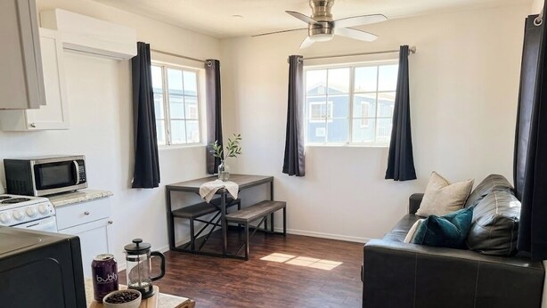 A compact living space with a kitchenette, a dining area, and a seating area. - Grand Canyon Gateway-Cozy Private Mobile Home Suite w/ Full Kitchen (Williams)