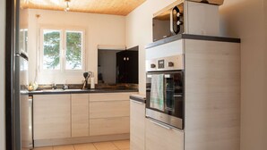 A modern kitchen with a built-in oven and a microwave. - Magic Mountain breathtaking view of Mt Stmichel Bay (Dragey-Ronthon)