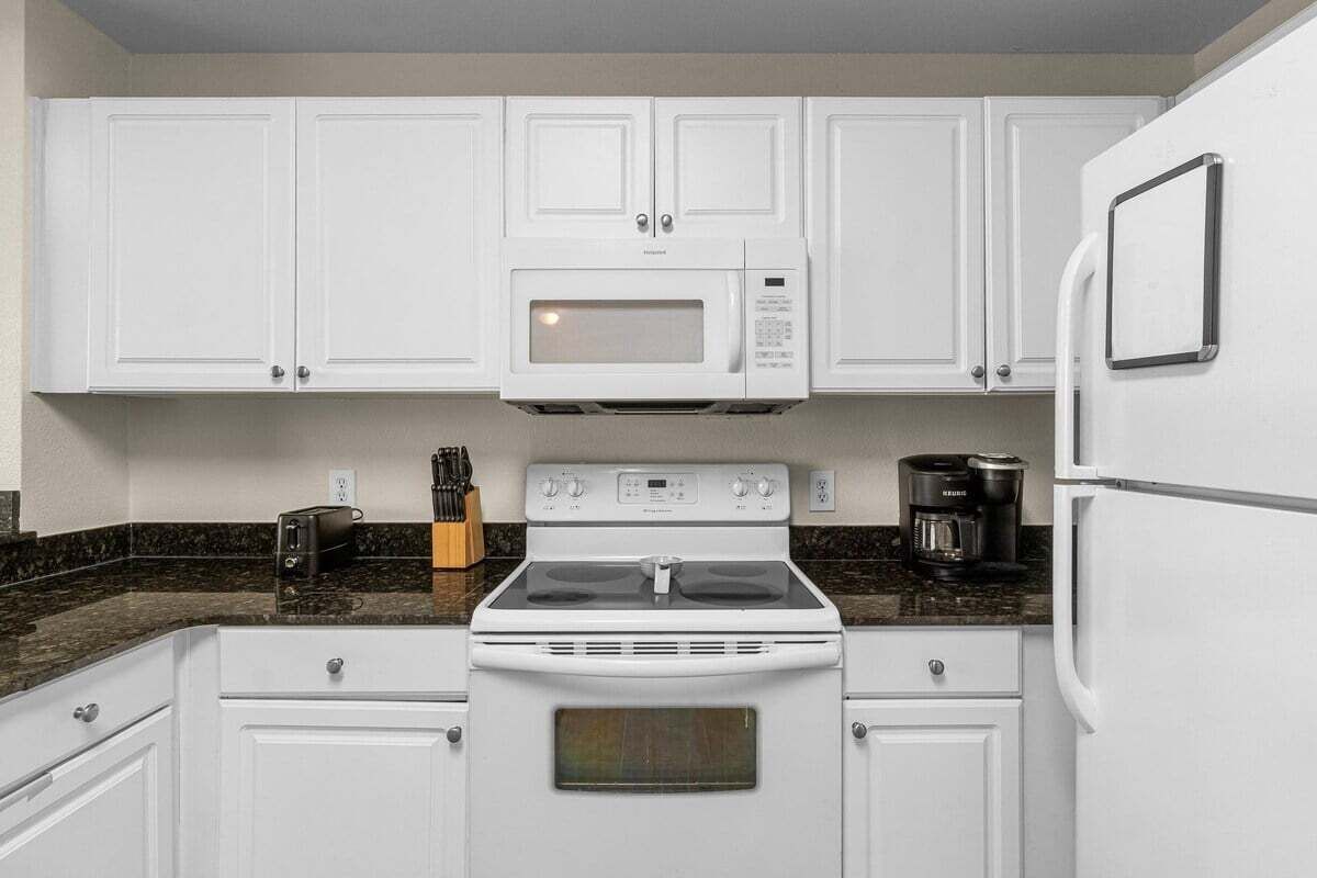 The kitchen features an electric stove, providing reliable and easy cooking for guests.