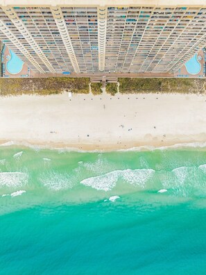 An aerial view of a beach with a large hotel structure. - Gulf Front, Huge Balcony & Near Pier Park | Tidewater 2003 (Panama City Beach)