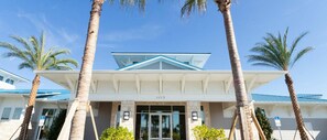 A hotel entrance with a modern design, featuring a prominent number '1115' above the door.