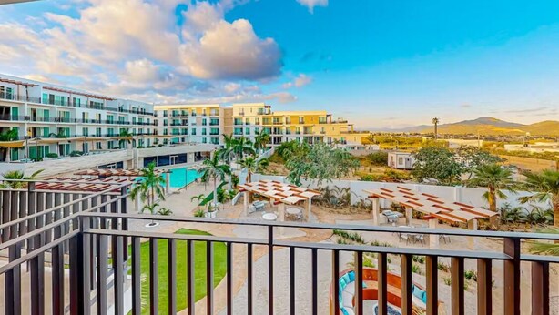 A hotel with multiple floors, outdoor pools, and a view of distant mountains. - Apartment C25, if you are looking for tranquility, this is the right place for you!  (San José del Cabo)