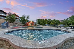 A hot tub area with a 3 FT depth limit and no driving sign, surrounded by lounge chairs and a small building. - Amazing 180° Lake Views | Boat Slip | 2-Min SDC (Branson)