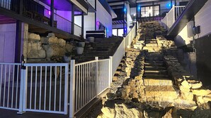 A modern building with a stone staircase leading to a balcony, surrounded by white railings. - Amazing 180° Lake Views | Boat Slip | 2-Min SDC (Branson)