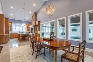 A spacious kitchen with a large island, wooden cabinets, and a chandelier. - Equestrian Estate | Indoor Pool, Theater, Game Rm (Schoharie)
