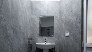 A modern bathroom with a white sink, a mirror, and a shower area. - Istana Villa Mirissa (Mirissa)