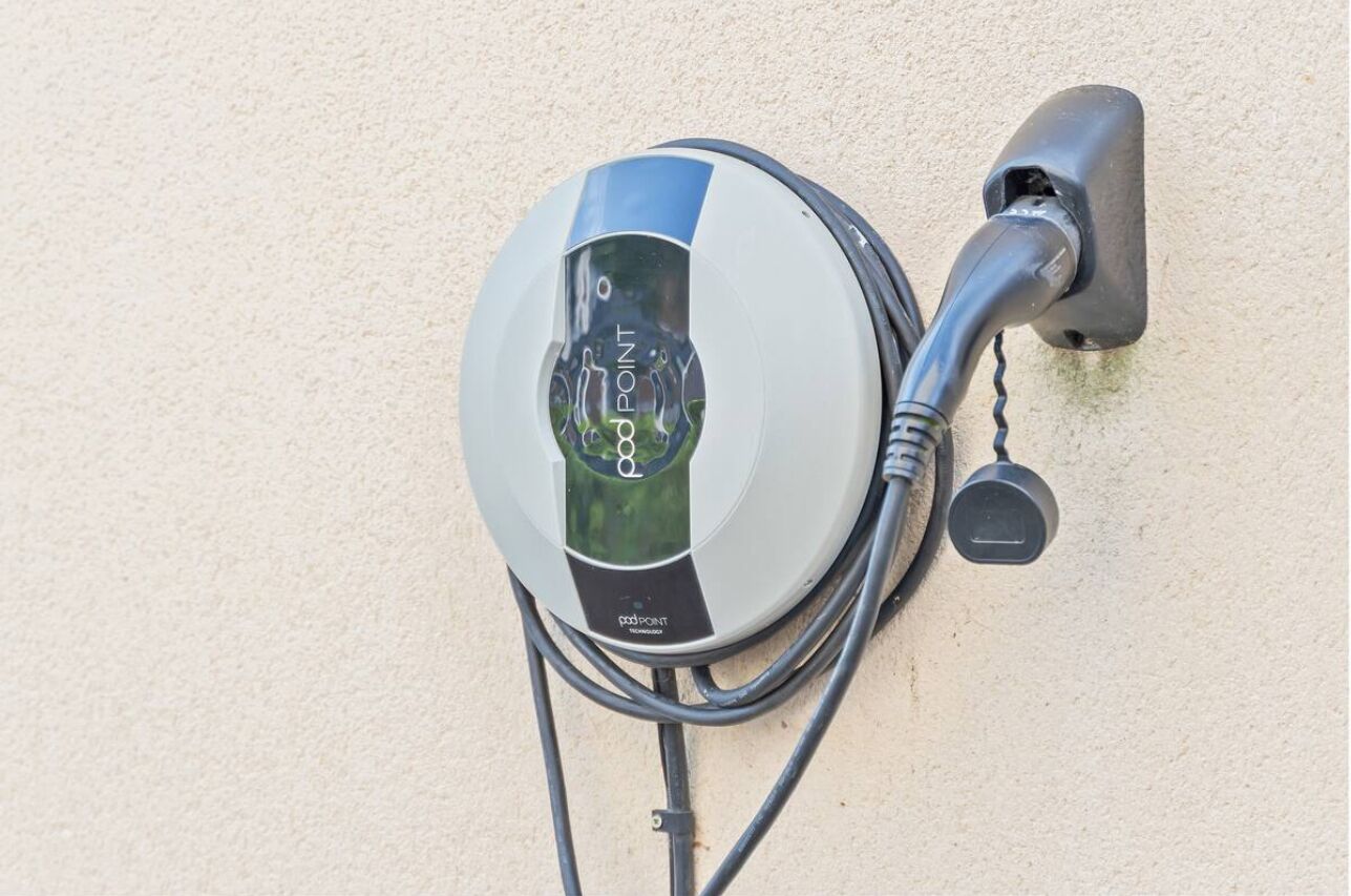 An electric vehicle charging station mounted on a wall.