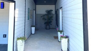 A building with a 'Welcome to the Lake' sign, a covered walkway, and potted plants along the sides. - Poolside | Lake Views | Game Room | 2-Min to SDC (Branson)