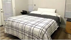 A bedroom with a bed, a desk, and a dresser. - Upgraded entire residential home (Scottsdale)