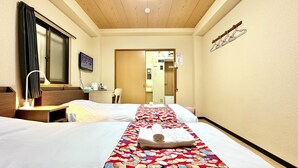 A hotel room with two beds, a desk, a chair, a desk lamp, a mirror, a window with curtains, and a wall-mounted coat rack. - Airport line, Hanazonocho station 2 min. apartment, tourist attraction Namba Shinsaibashi 3 station excellent access [ 102]. (大阪市西成区花園北2丁目)
