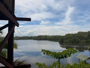 A view of a lake with a wooden structure in the foreground, likely a part of a hotel or resort. - Oasis Paradise Hotel (Tela)