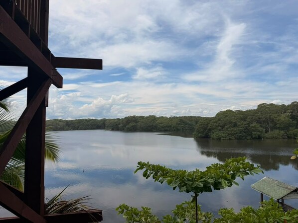 A view of a lake with a wooden structure in the foreground, likely a part of a hotel or resort. - Oasis Paradise Hotel (Tela)