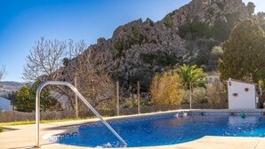 A swimming pool with a view of a rocky mountain and a building in the background. - 3 bedroom lovely home in Montejaque (Montejaque)