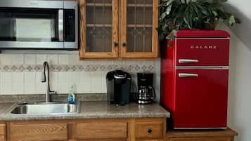 Fridge, microwave, coffee/tea maker, cookware/dishes/utensils