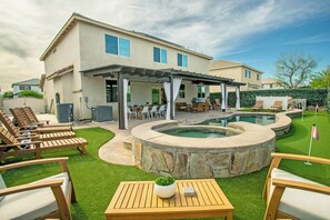 A backyard with a hot tub, outdoor seating, and a covered patio area. - Tranquility Meets Adventure in the Heart of the Desert Near Events & Attraction (Coachella)