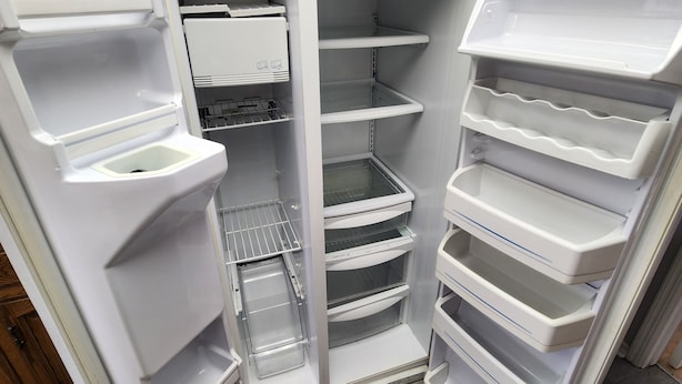 A fully stocked refrigerator with multiple shelves and compartments.