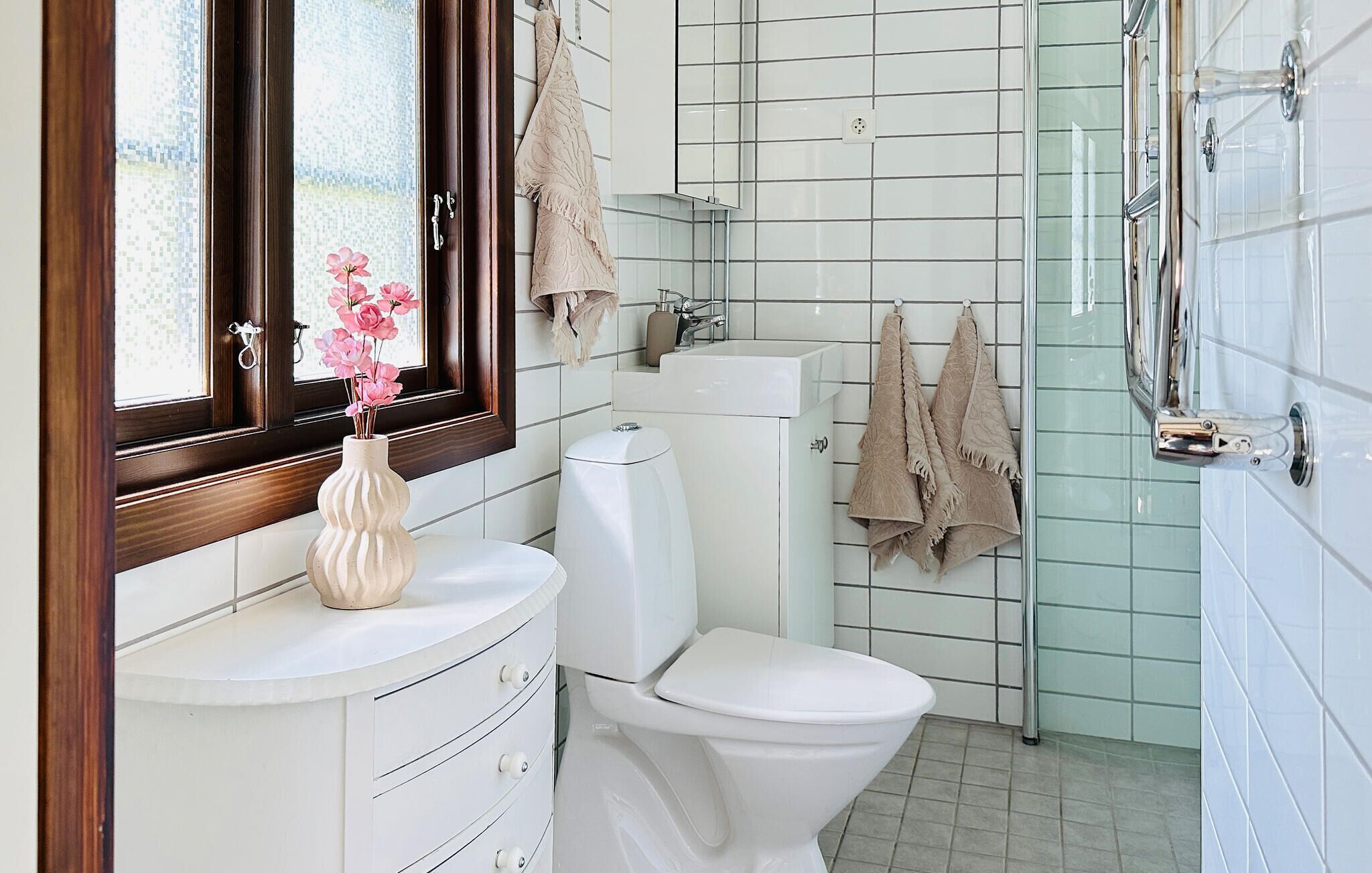 A bathroom with a toilet, sink, and shower.
