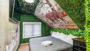 A bedroom with a bed, a dresser, a window with blinds, and a mural on the wall. - ★★ The Red Lion ★★. OSU British Pubcade Castle (Columbus)