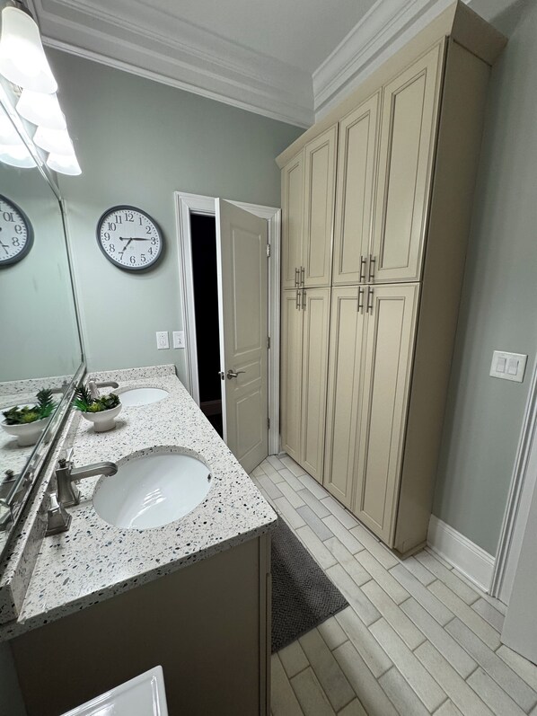 A bathroom with two sinks, a mirror, and a walk-in closet with doors. - Waterfront condo. Walk to restaurants, and a short drive to beach, and Southport (Southport)