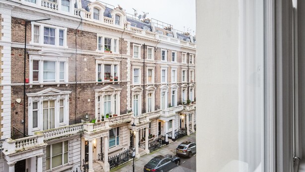 A row of traditional brick townhouses with white facades, multiple windows, and balconies. - Blueground | Notting Hill, w/d, nr Hyde Park (London)
