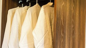 A wooden wardrobe with multiple hanging spaces. - Keang You Boutique Hotel  (Phnom Penh)