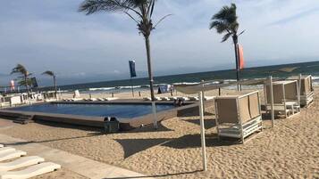 On the beach, sun-loungers