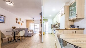 Un appartement moderne comprenant un coin repas, un salon et une cuisine.