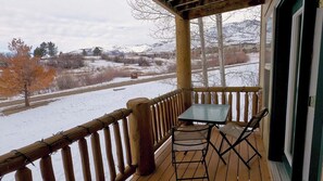 A wooden deck with a table and chairs, overlooking a snowy landscape with mountains in the distance. - Classic 3BD 3BTH at Moose Hollow, view of Mtns (Eden)