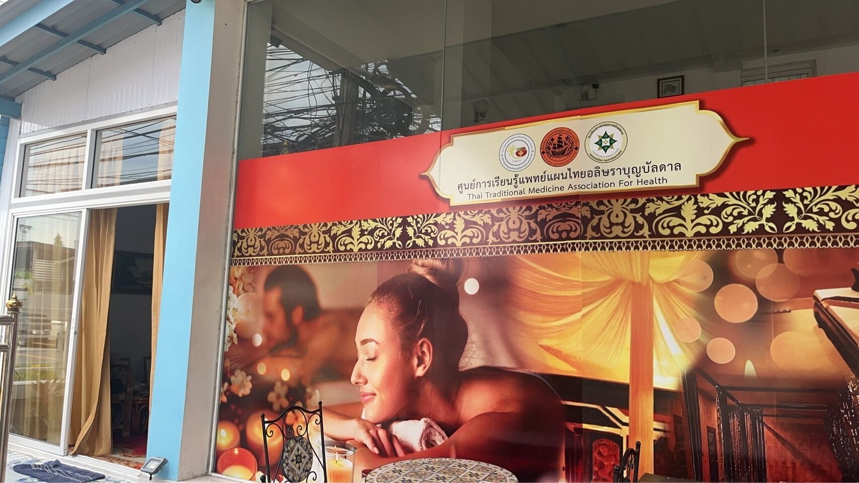 A Thai Traditional Medicine Association For Health sign with a traditional Thai design.