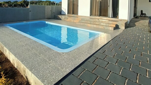 A modern two-story house with a swimming pool and a paved patio. - Lux Villa in Island of Mauritius, Grand Baie hidden Gem with poolside Bliss (Grand Baie)