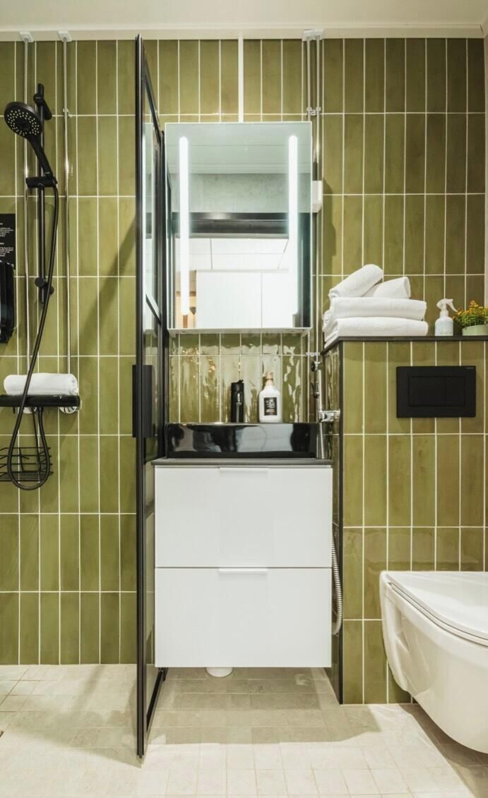 A bathroom with a shower, a sink, and a toilet.