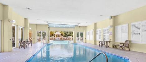 A swimming pool with a clear view of the pool area, including the poolside chairs and the pool's edge.