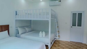 A room with a bunk bed, a single bed, and a door. - Rungmod 99 Villa (Khanom)