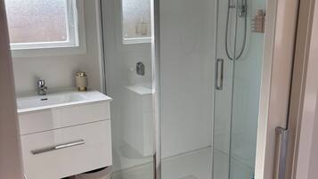 Shower, hair dryer, towels, soap