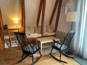 A cozy living room with a sofa, two rocking chairs, a coffee table, and a lamp. - Mountain chalet with balcony, near slopes and center (Besse-et-Saint-Anastaise-Super Besse)