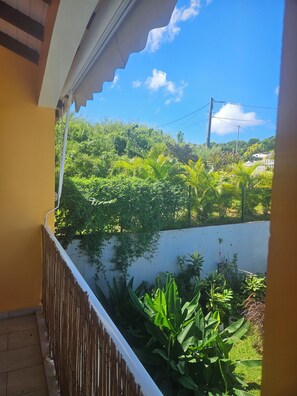 Enjoy breathtaking views of lush vegetation from this balcony.