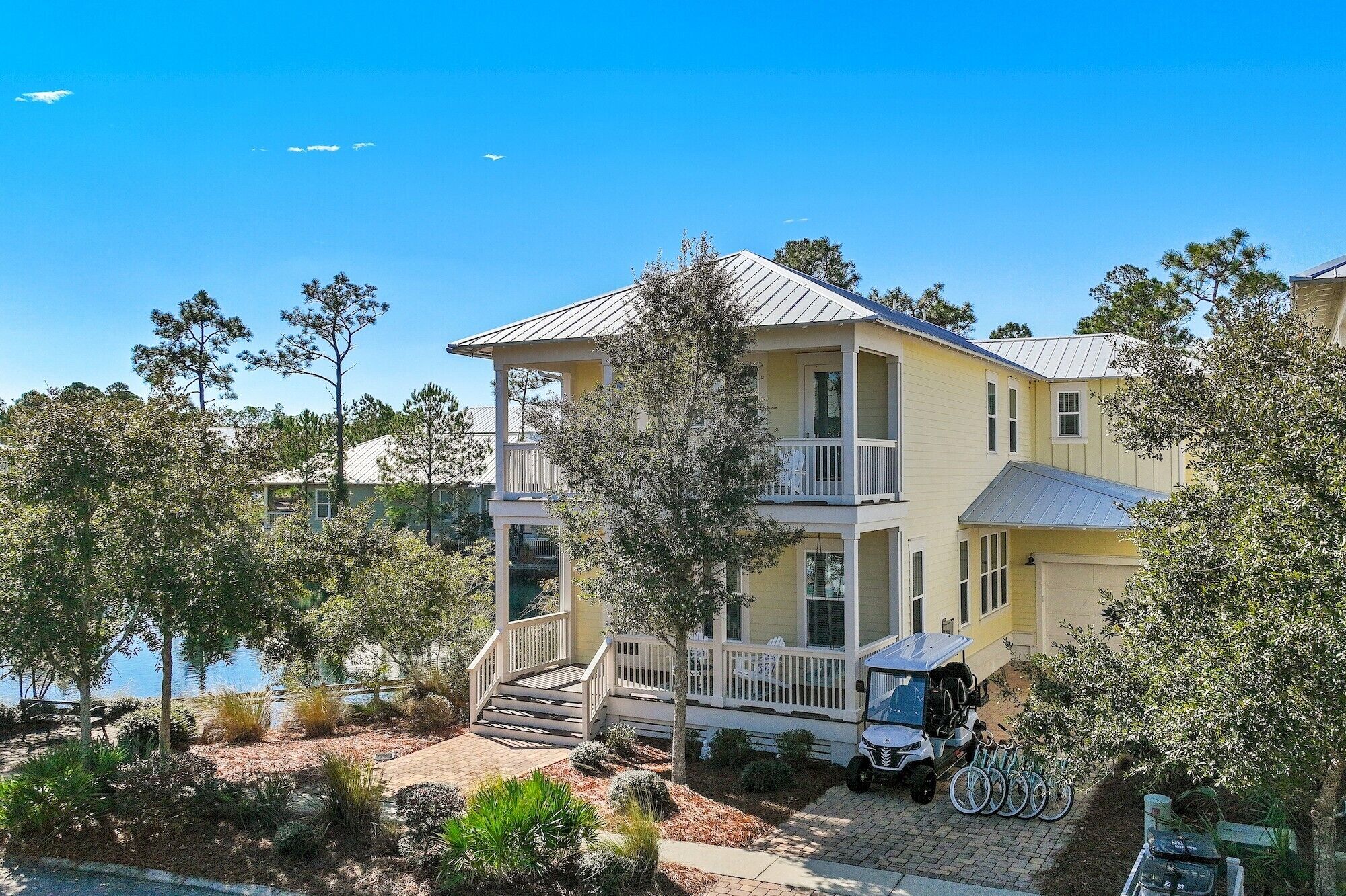 A two-story house with a balcony, a covered porch, and a garage.