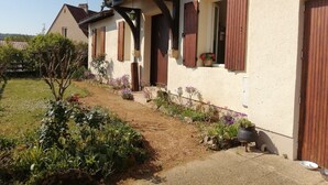 A row of houses with wooden shutters, a garden with various plants, and a clear sky. - Quiet house with garden Montignac Lascaux (Montignac-Lascaux)
