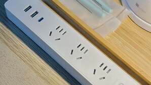 A white power strip with multiple outlets and USB ports on a wooden surface. - Along the airport line, 2 min. from Hanazono station, Japanese-style room with private bathroom Apartment for rent [ 202]. (大阪市)