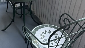 A round table with a mosaic tile design and metal chairs with matching patterns. - Along the airport line, 2 min. from Hanazono station, Japanese-style room with private bathroom Apartment for rent [ 202]. (大阪市)
